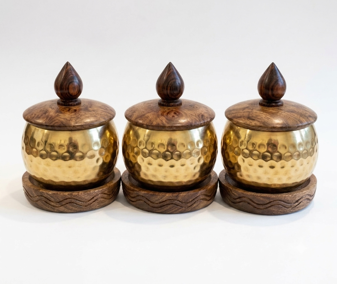 RB ARTISAN Brass Hammered Spice Jar Set of 3 - Wooden Base & Lid RB ARTISAN handcrafted brass hammered spice jar set of 3 with wooden base lid and spoon filled with salt cardamom and turmeric made in India