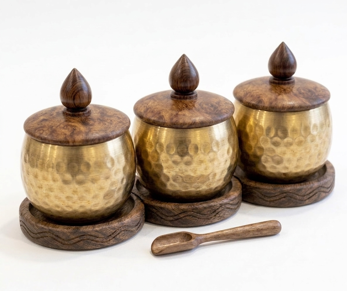 RB ARTISAN Brass Hammered Spice Jar Set of 3 – Wooden Base & Lid RB ARTISAN handcrafted brass hammered spice jar set of 3 with wooden base lid and spoon filled with salt cardamom and turmeric made in India